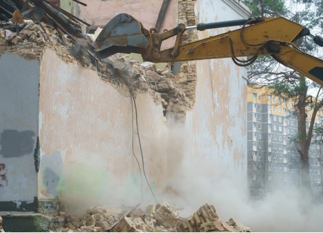 Excavator removing structural walls during Dallas demolition by Best Dallas Demolition