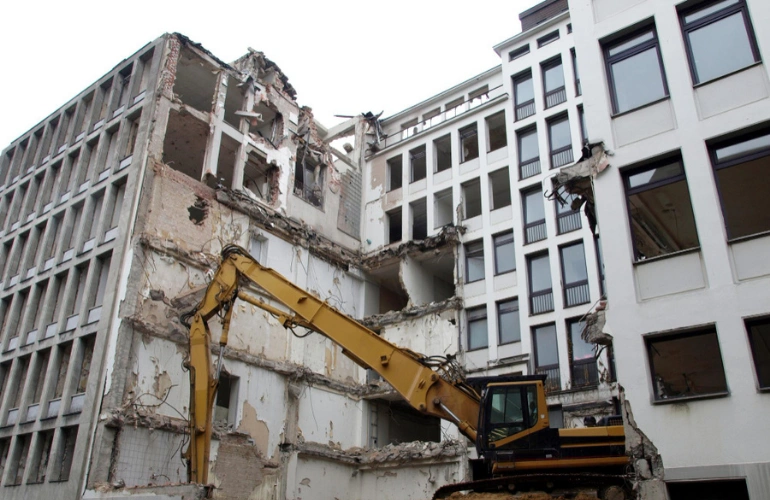 Commercial building demolition in Dallas Texas by Best Dallas Demolition using heavy excavator